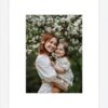 Framed photo of a mother and daughter embracing under a blooming tree.